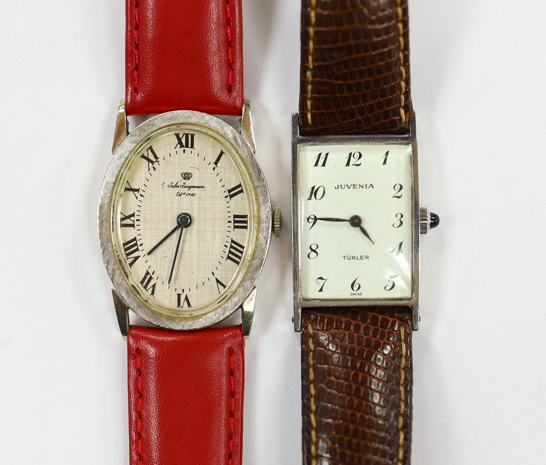 A 14k white metal Jules Jurgensen oval manual wind dress wrist watch, on an associated red leather strap, together with a lady's steel Juvenia manual wind wrist watch.